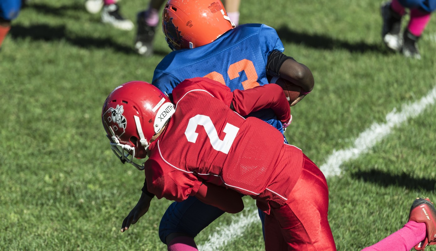 Making a tackle during a Pop Warner football game